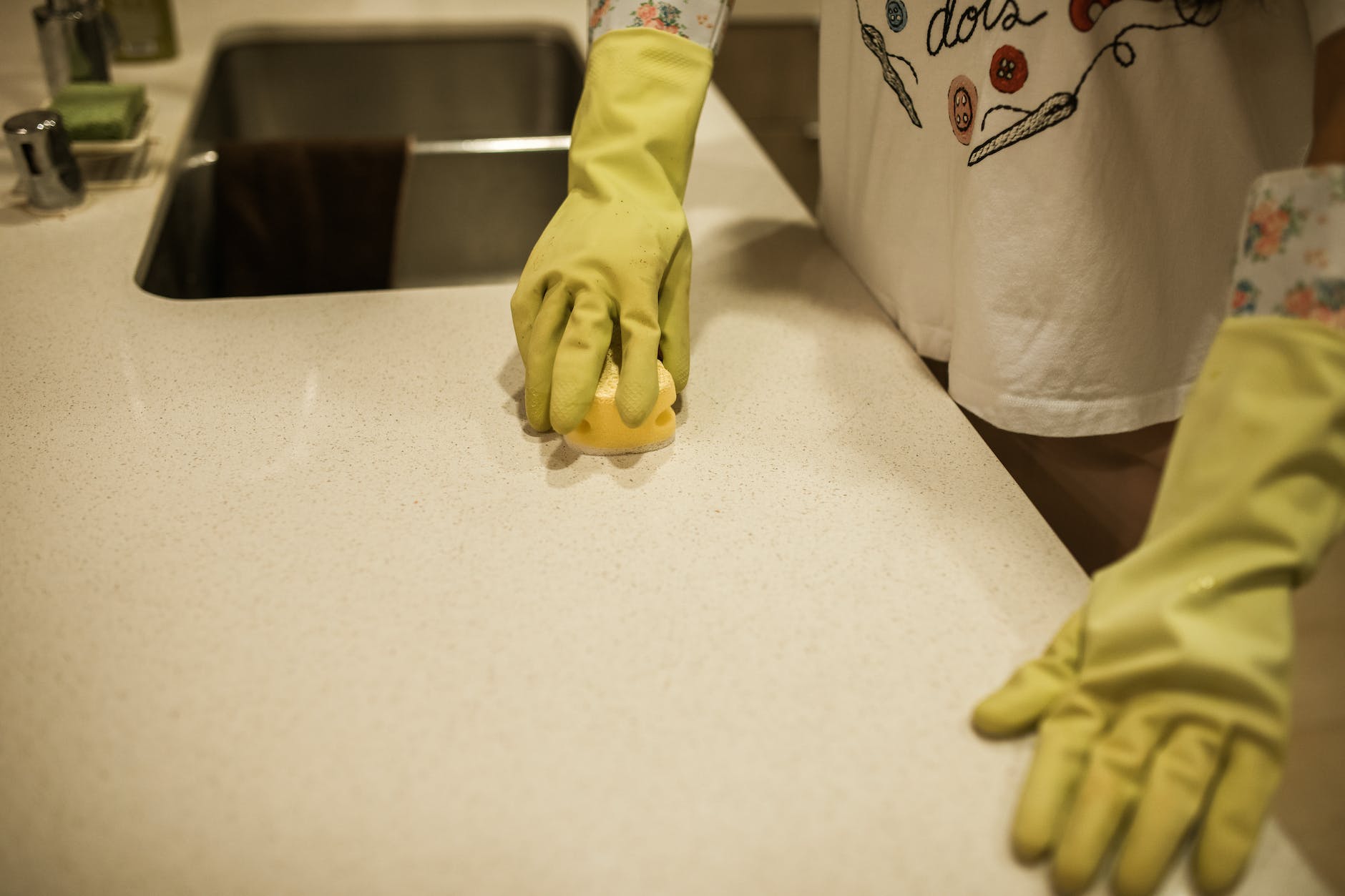 a person cleaning a kitchen counter